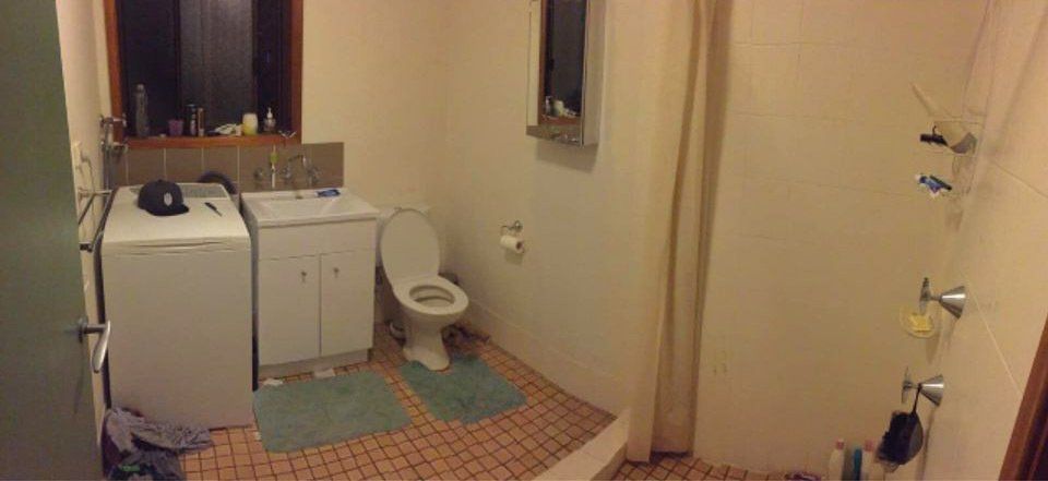Older-style bathroom with toilet and vanity